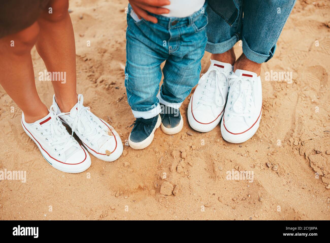 Belle photo de trois paires de chaussures maman, papa et bébé fils sur la  plage Photo Stock - Alamy