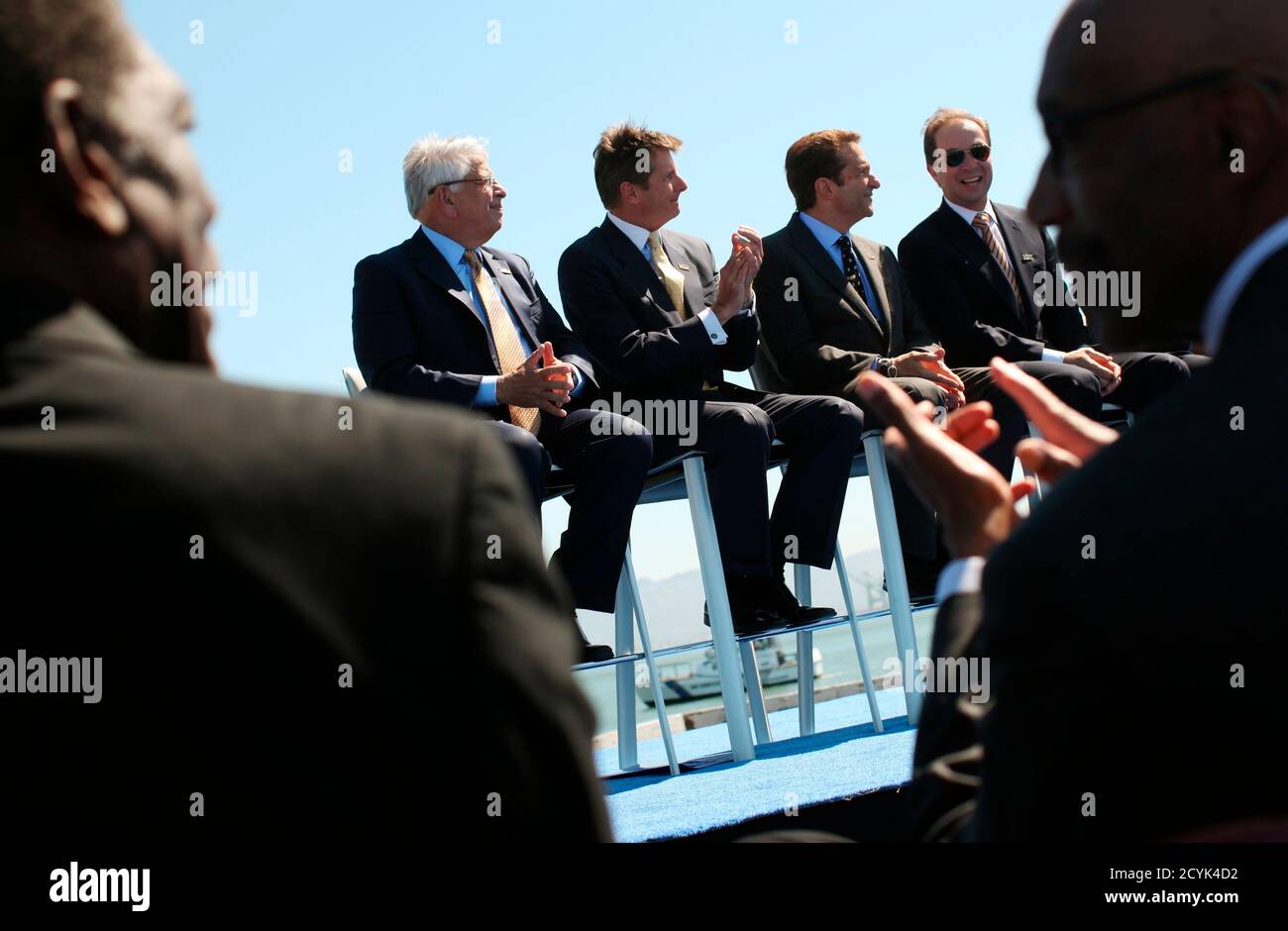 Former Golden State Warriors players Al Attles (L) and Nate Thurmond  applaud as they frame NBA Commissioner David Stern (2nd L) and Warriors  executives during an announcement of the team's plans to