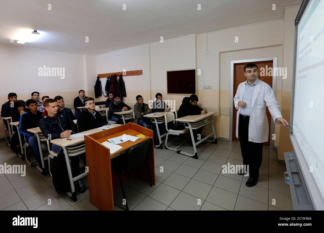 a teacher points to the board as he teaches students during a class at fem university preparation school in uskudar november 27 2013 at the fem university preparation school in uskudar a