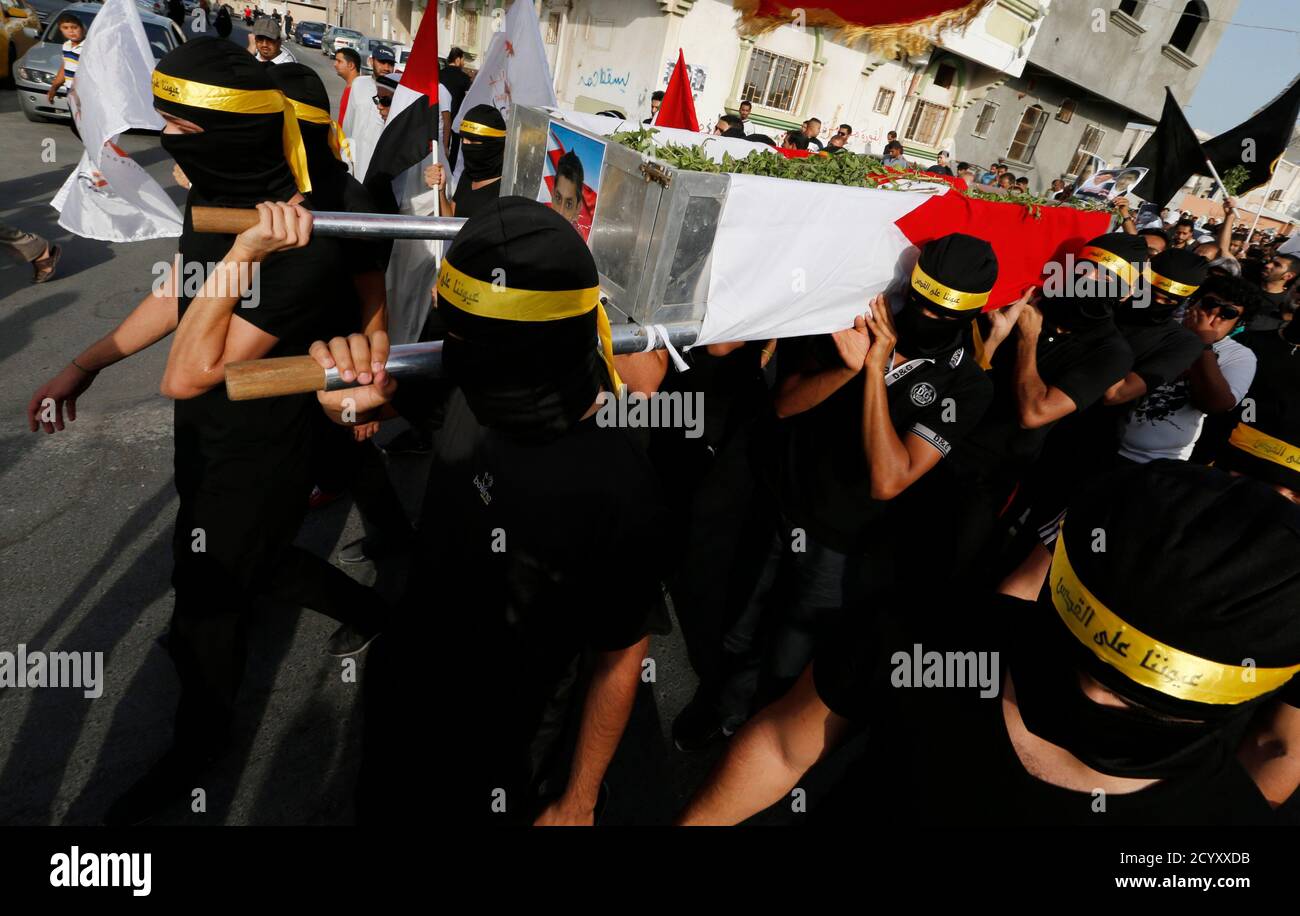 The body of Mahmood Abbas Alaradi is carried by his friends, dressed as  martyrs, during his funeral procession in the village of Sitra, south of  Manama August 2, 2013. Alaradi and Ali