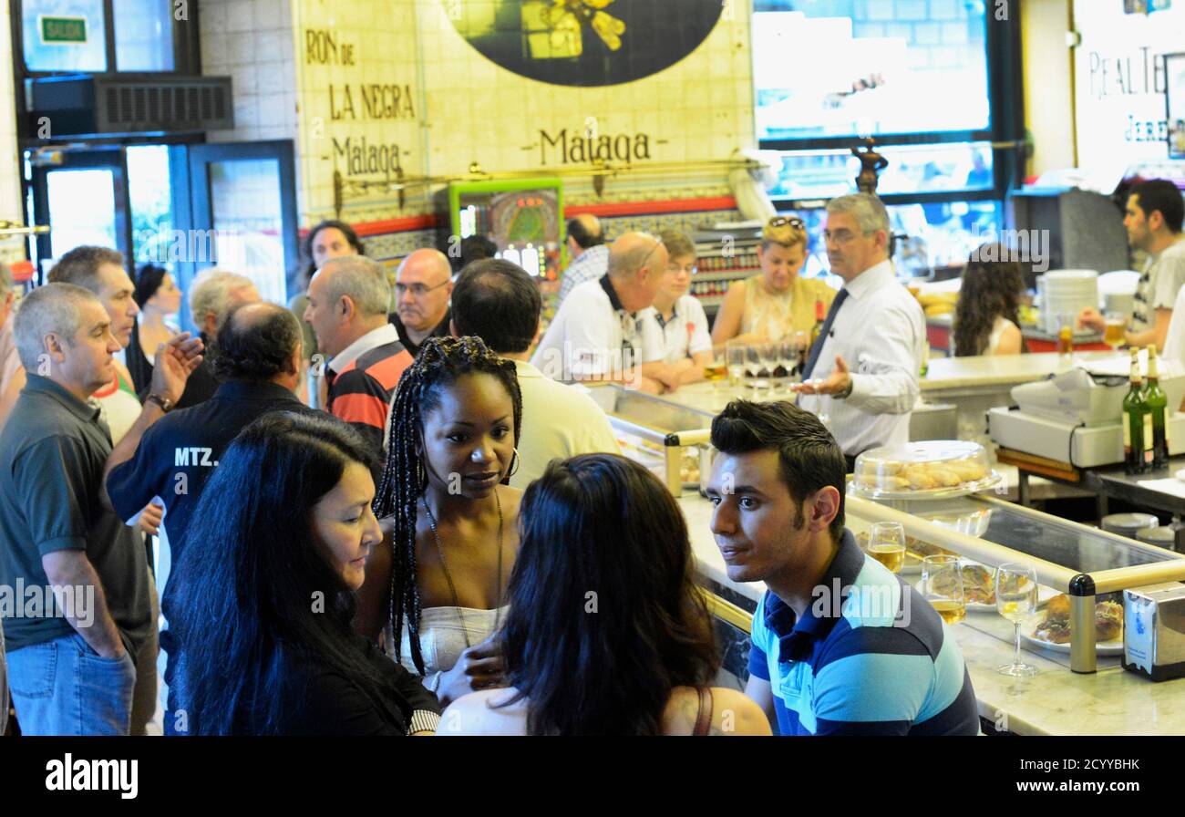 People socialise at the Iruna bar in downtown Bilbao, June 24, 2012. About  an hour's flight from Madrid, Bilbao sits inland from the Bay of Biscay.  Signs appear in both Basque and