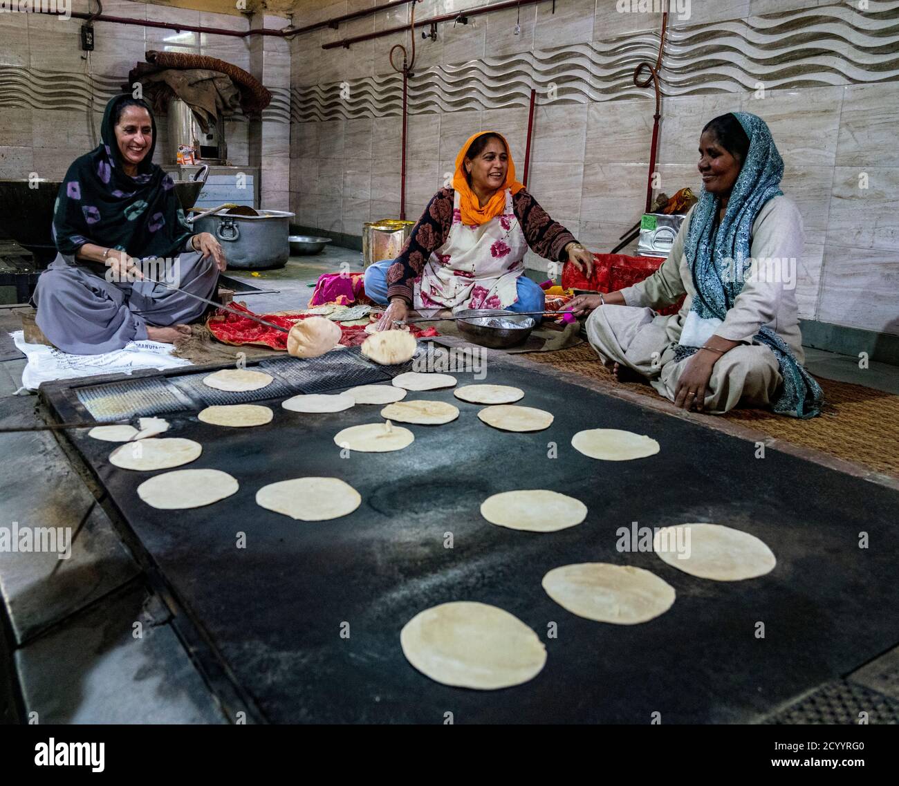 New Dehli, Inde, 20 févr. 2018 - les femmes préparent du pain à la poêle pour des repas gratuits pour les visiteurs sikhs au temple Banque D'Images