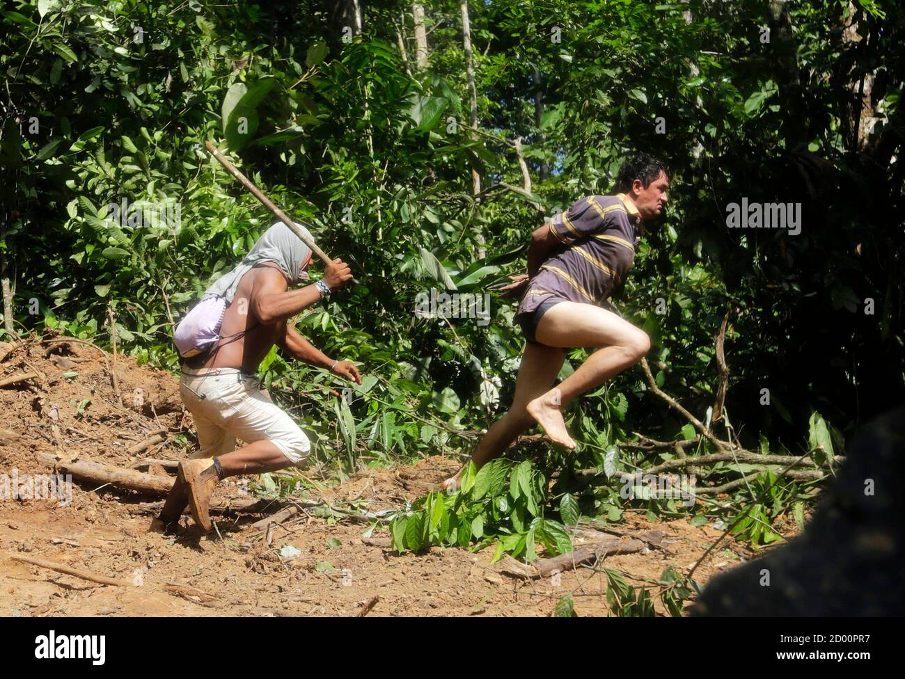 A Ka'apor Indian warrior (L) chases a logger who tried to escape after he  was captured during a jungle expedition to search for and expel loggers  from the Alto Turiacu Indian territory,