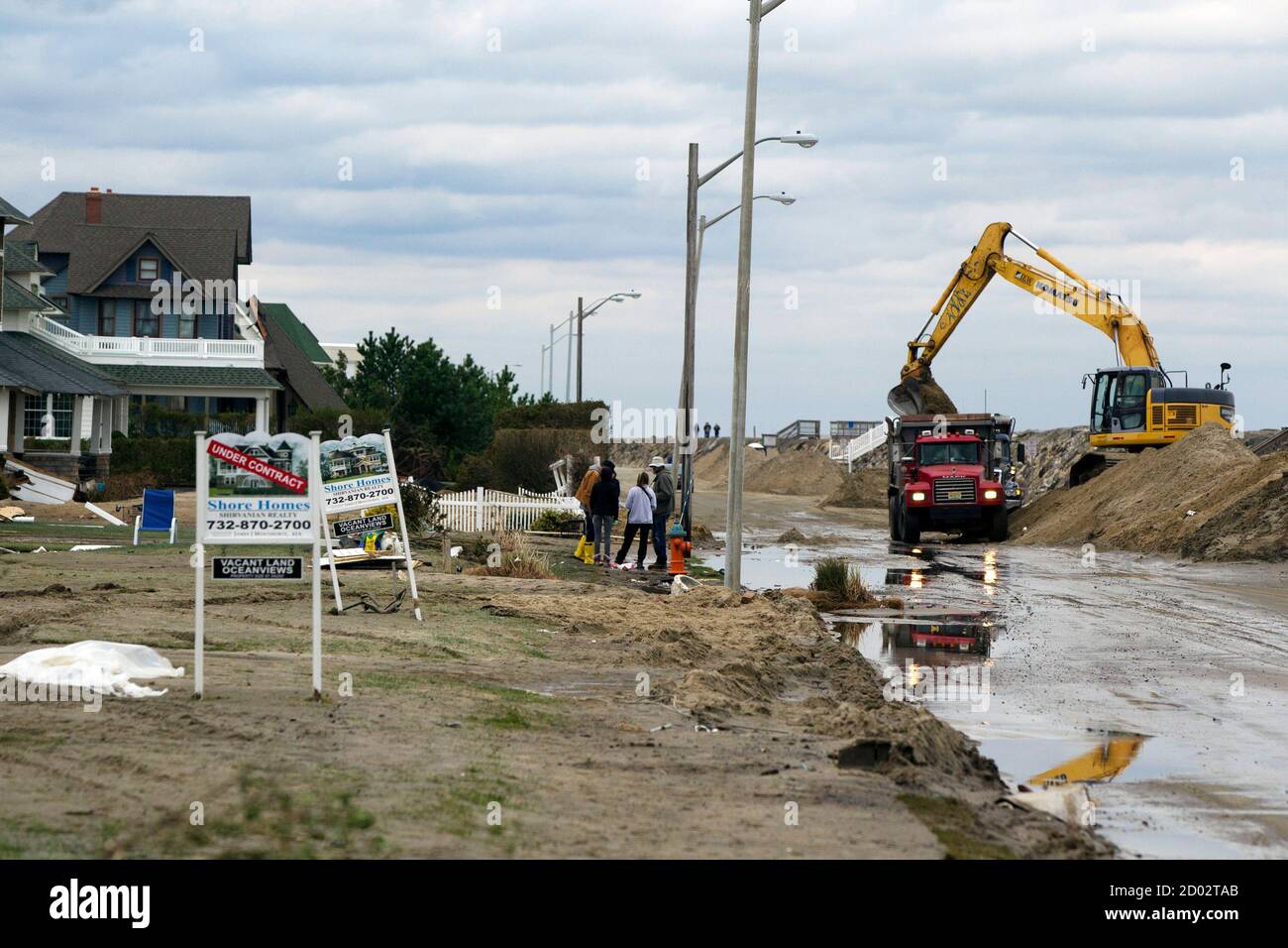 People watch several feet of sand being removed from a ...