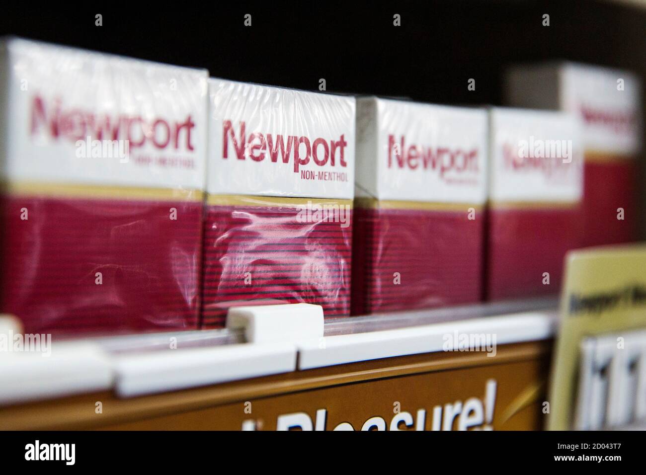 Newport and Camel cigarettes are stacked on a shelf inside a tobacco store  in New York July 11, 2014. U.S. cigarette maker Reynolds American Inc is in  talks to acquire rival Lorillard