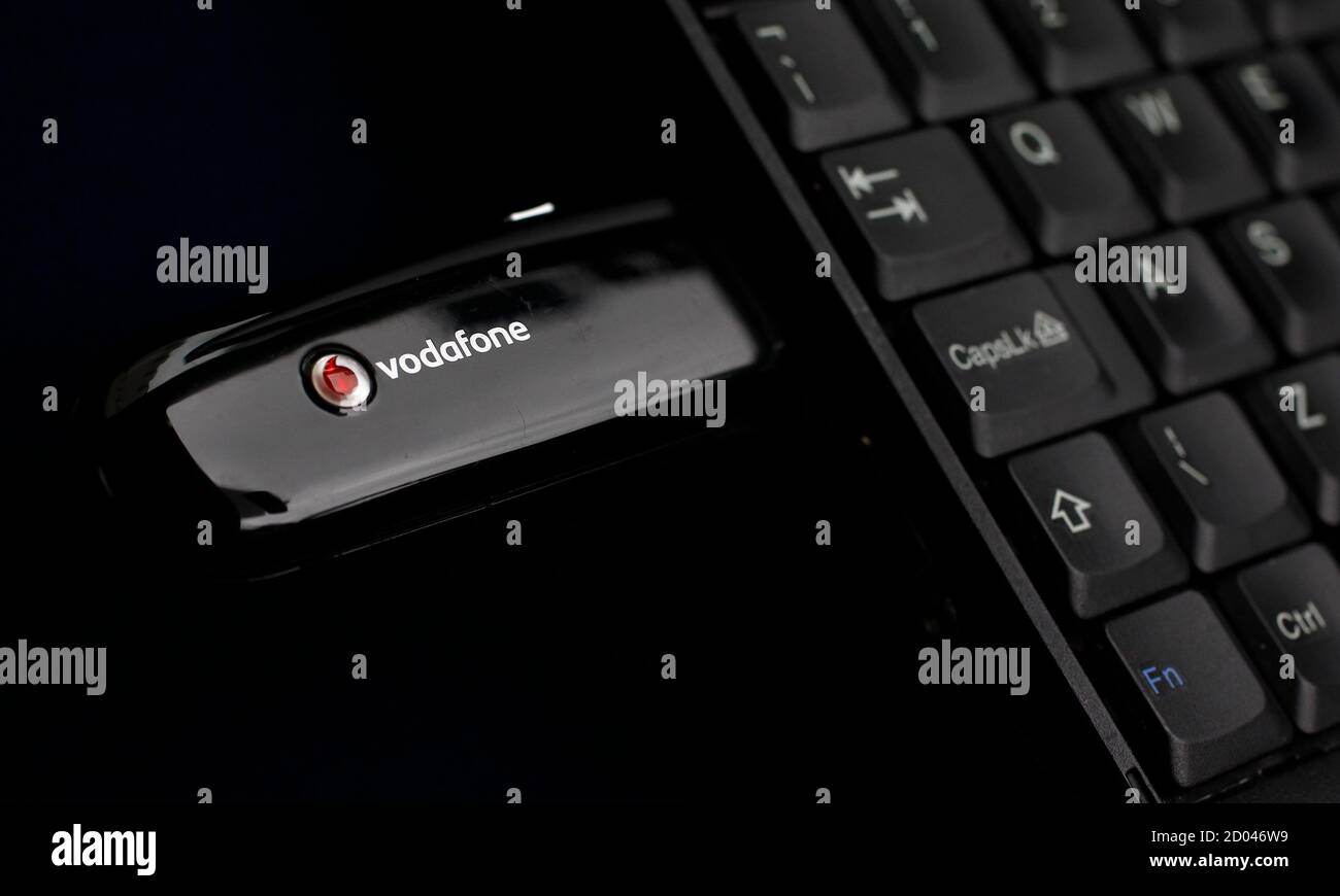A Vodafone mobile internet dongle is seen connected to a laptop in London  November 9, 2010. Vodafone , the world's largest mobile operator by  revenue, raised its full-year outlook and announced the
