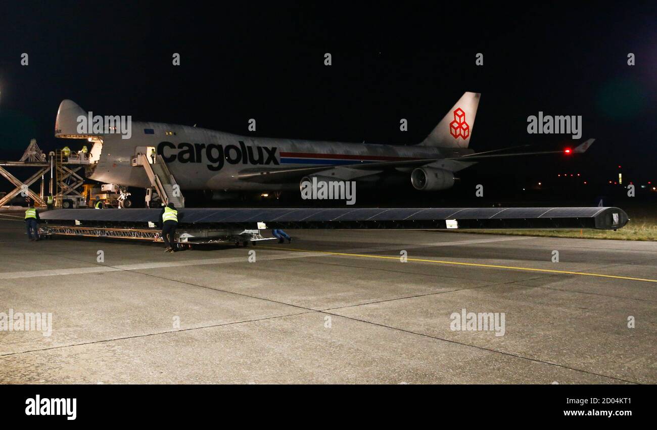 An element of a wing of the dismantled Solar Impulse 2 aircraft is carried  towards a Cargolux Boeing 747 cargo aircraft at Payerne airport January 5,  2015. The Solar Impulse 2 aircraft