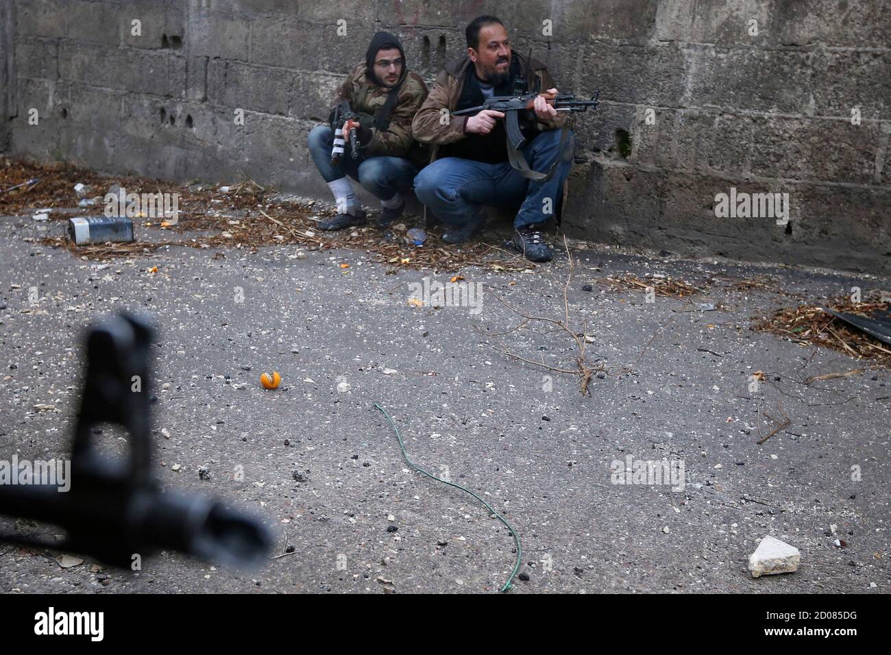 Syrian rebels line an alleyway while preparing to attack a government  controlled army checkpoint in the Ain Tarma neighborhood of Damascus  January 30, 2013. Reuters photographer Goran Tomasevic has won first prize