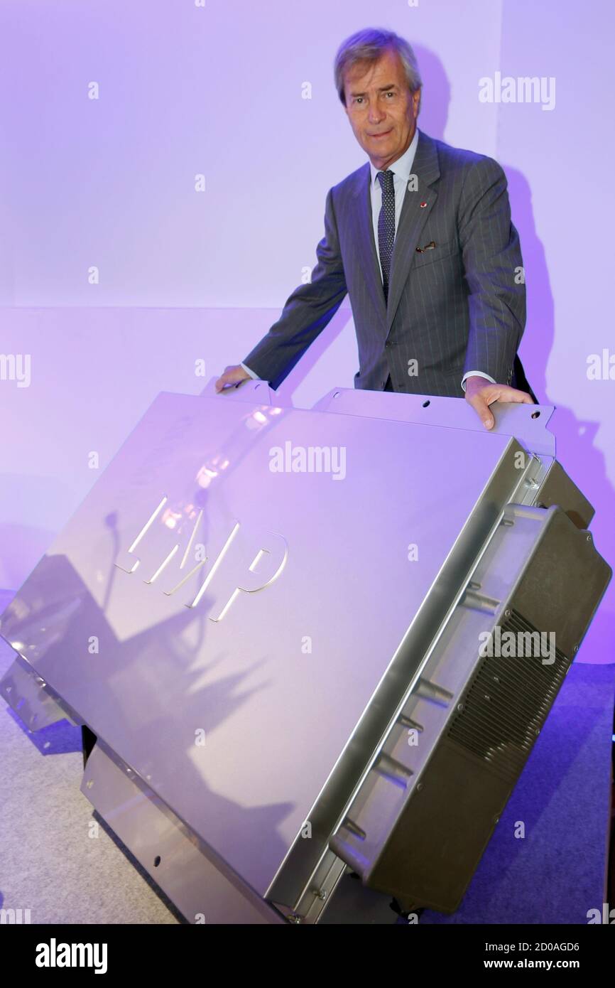 Vincent Bollore, CEO of investment group Bollore, poses with a  Lithium-Metal-Polymer (LMP) battery before a news conference in Paris  October 17, 2013. Bollore group said the stock market listing of electric  car