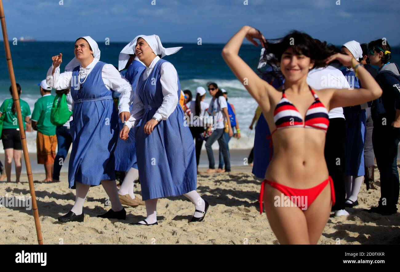 Nuns and sunbathers wait for the arrival of Pope Francis on Copacabana  beach in Rio de Janeiro, July 26, 2013. Pope Francis on Thursday issued the  first social manifesto of his young