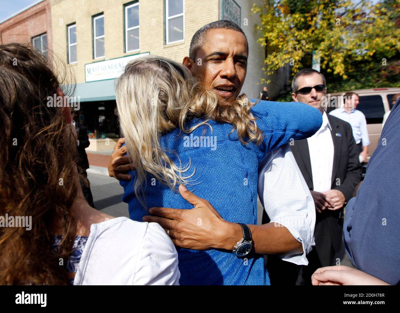 U.S. President Barack Obama hugs a young woman after picking candy for  Halloween treats outside Mast General Store in Boone, North Carolina,  October 17, 2011. Obama began a three day bus trip