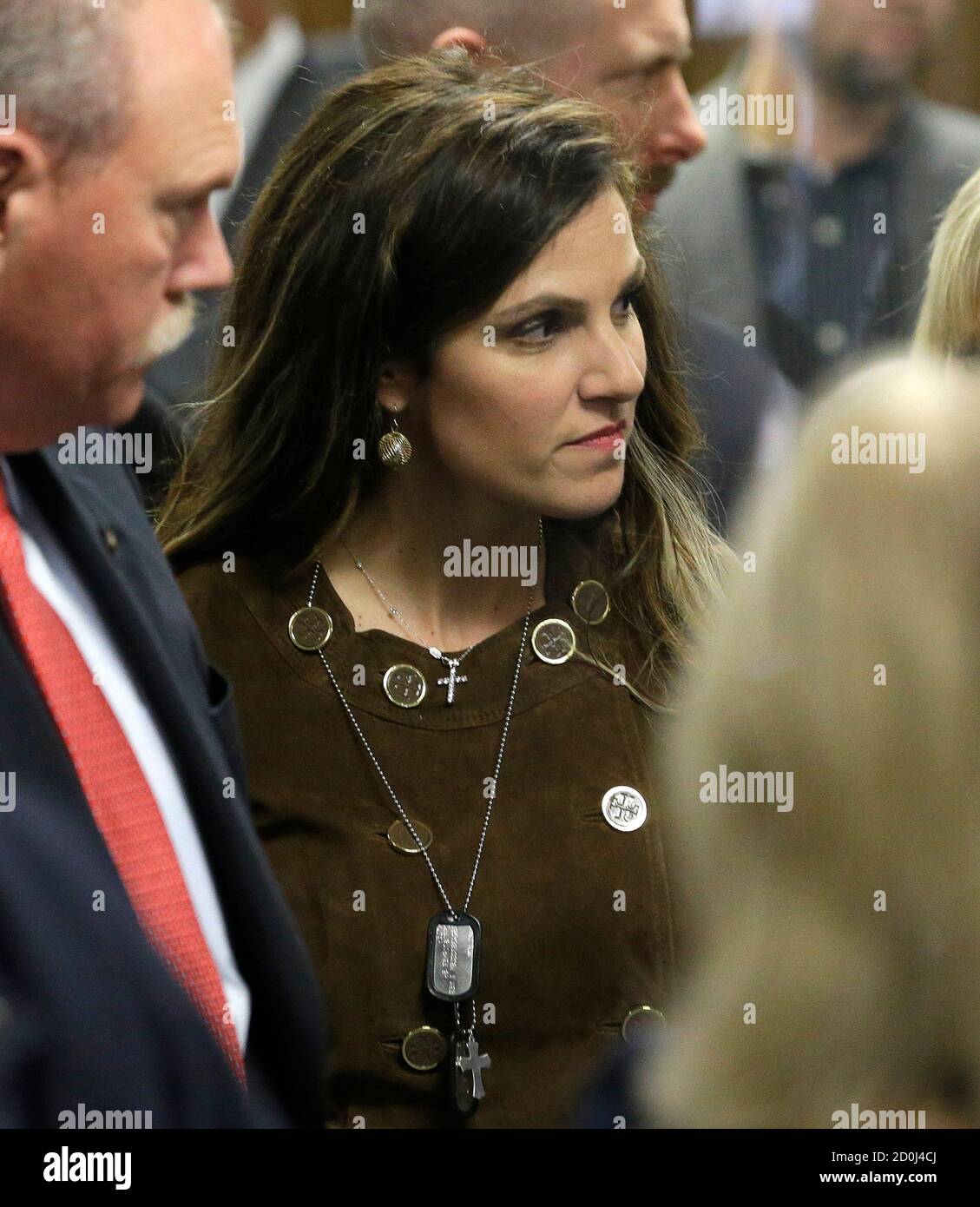 Taya Kyle, widow of former Navy SEAL Chris Kyle, wears her husband's  military dog tags as she walks out of the courtroom during a break in the  capital murder trial of former