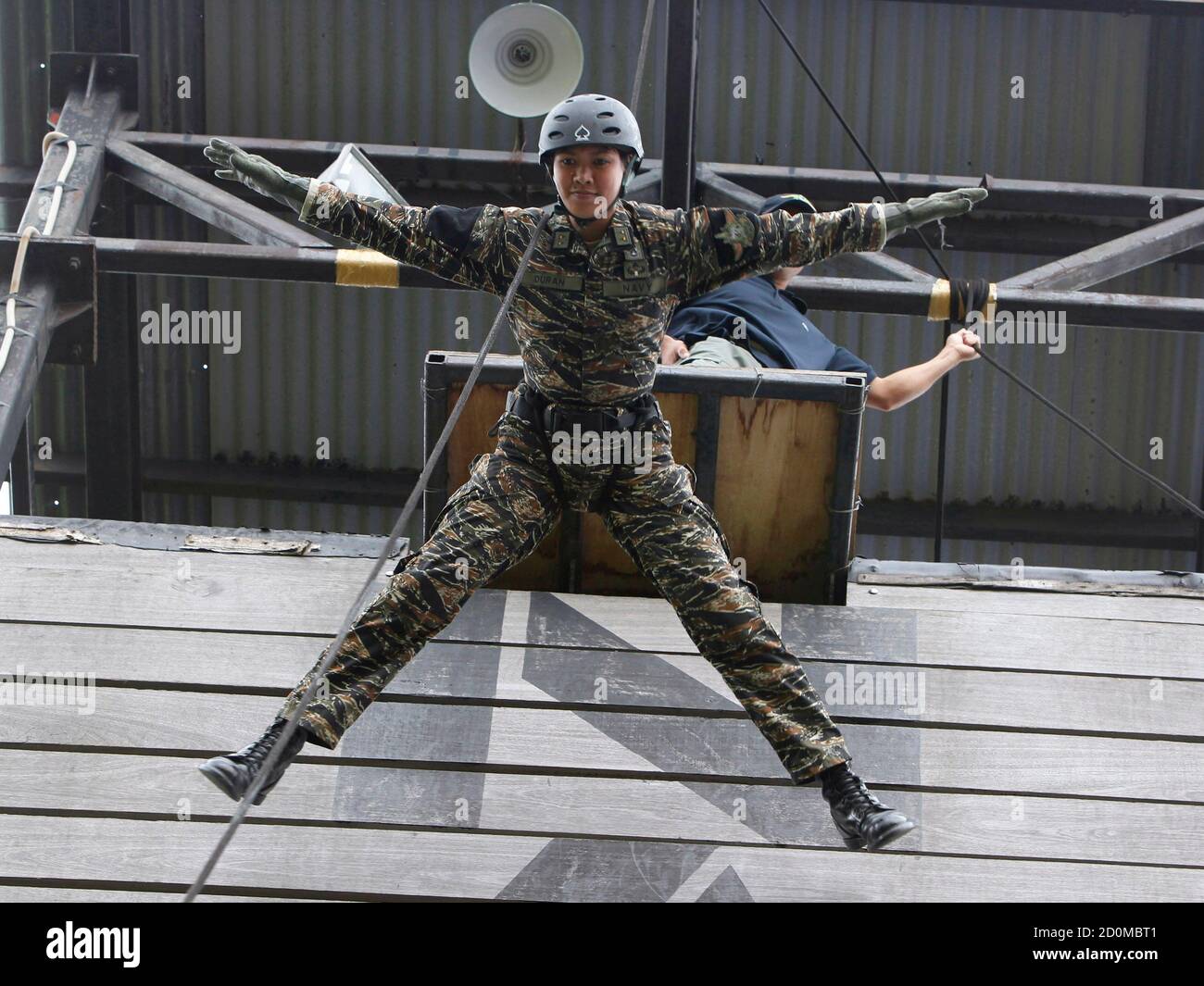 Lieutenant Junior Grade Michelle Duran, the first female airborne officer  of Naval Special Operations Group, demonstrates her rappel skills during a  drill inside the Philippine Navy headquarters in Sangley Point, Ternate  town,
