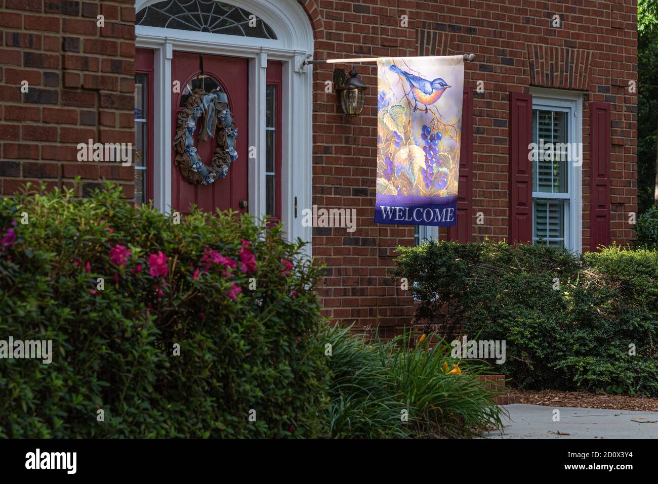 Drapeau de bienvenue à l'entrée de la porte d'entrée d'une maison haut de gamme en briques à Lilburn (Metro Atlanta), Géorgie. (ÉTATS-UNIS) Banque D'Images
