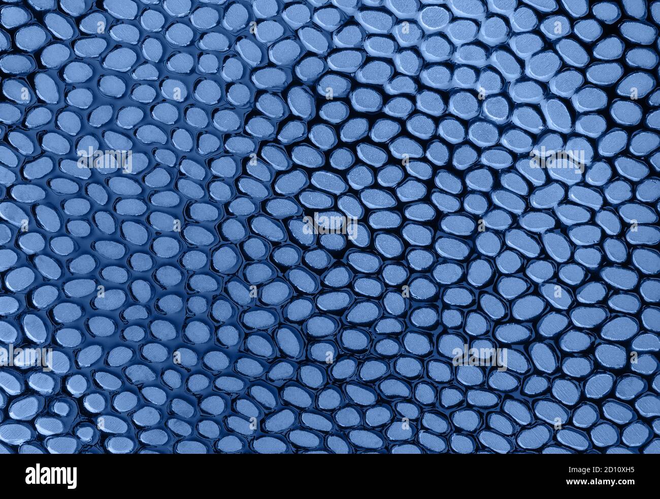 Arrière-plan abstrait de taches arrondies mates sur une surface brillante couleur bleu classique tendance de l'année 2020. Surface et texture en tant qu'élément de conception. Banque D'Images