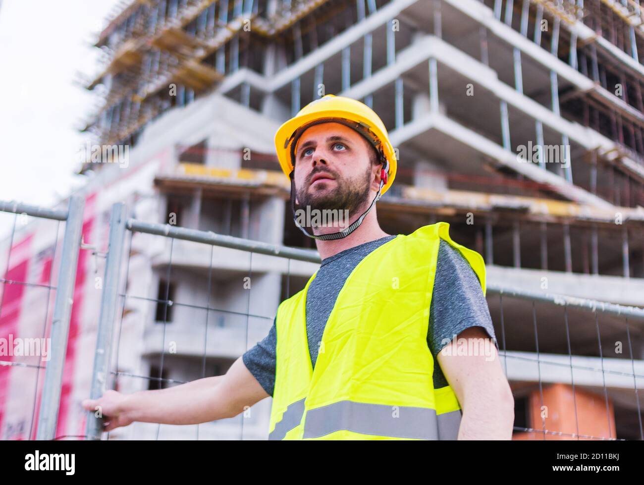 Ouvrier de construction de bâtiment engereneer regardant le bâtiment l'interprétation il travaille sur Banque D'Images