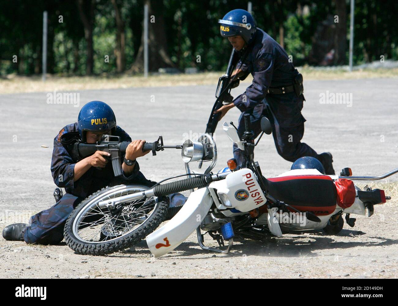 Philippine National Police (PNP) members of the Regional Mobile Group (RMG)  who completed the Basic Motorcycle Patrol Operation Training show their  skills during a live-fire exercise inside a police headquarters in Taguig