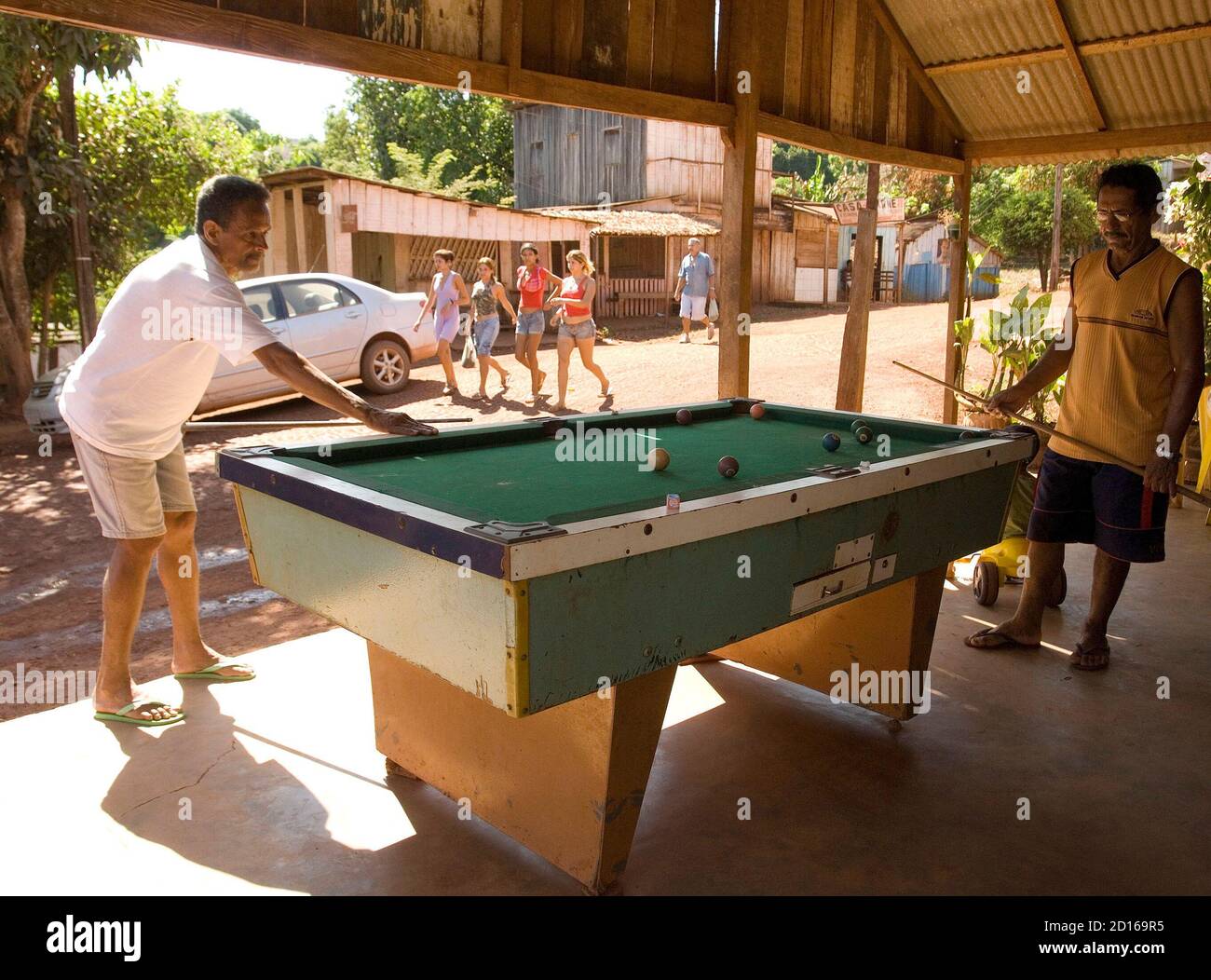 Men play billiards along a main street of the town built in the 1980's  around the gold mine called Serra Pelada, where more than 60,000 men dug a  massive crater in the