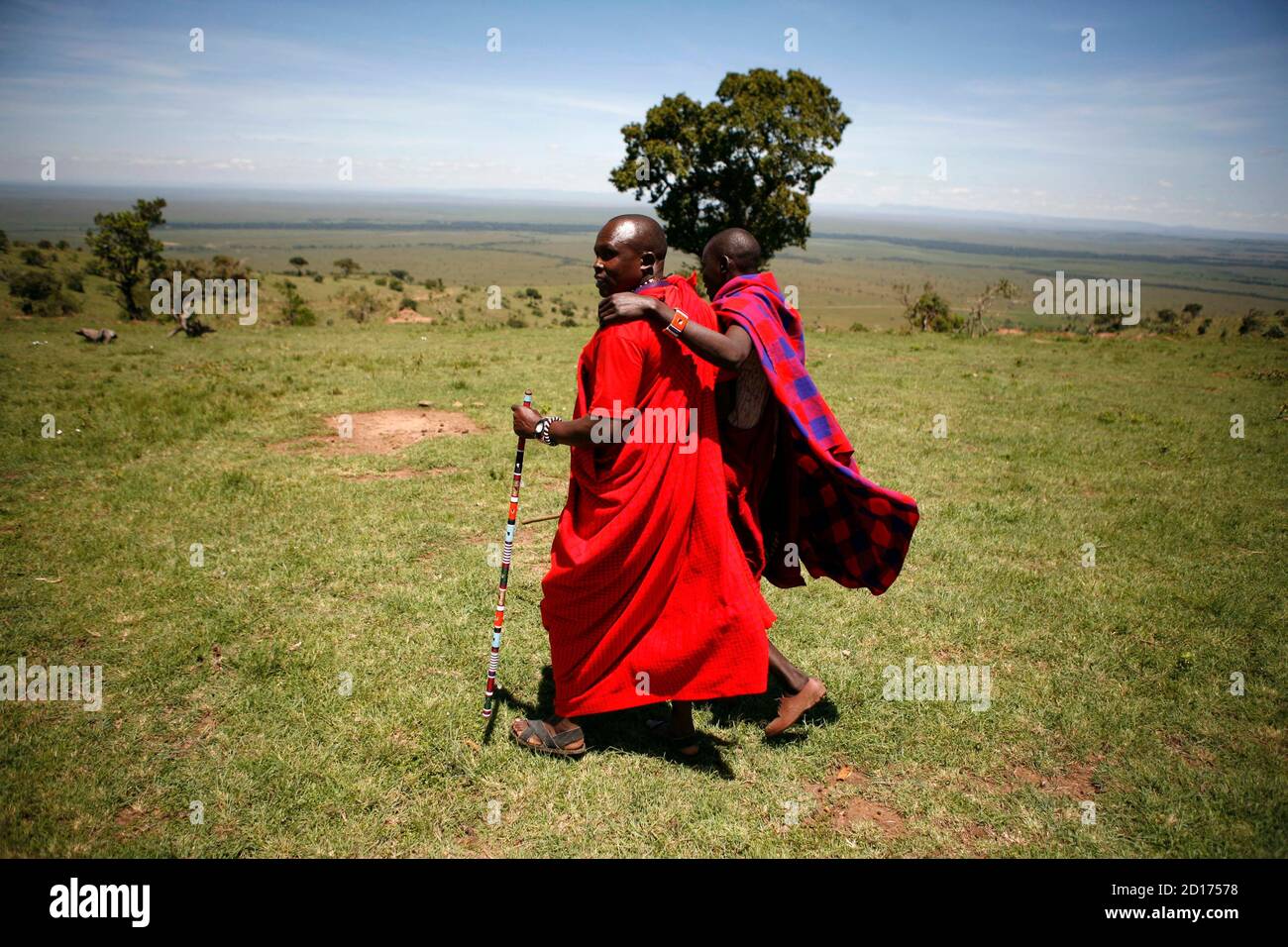 Two Maasai Men Walk Together Outside Enkereri Village Near Maasai Mara Game Reserve Which Is Seen In The Background April 3 08 The Maasai Tribesmen Of The Oloololo Escarpment Have Been Hit