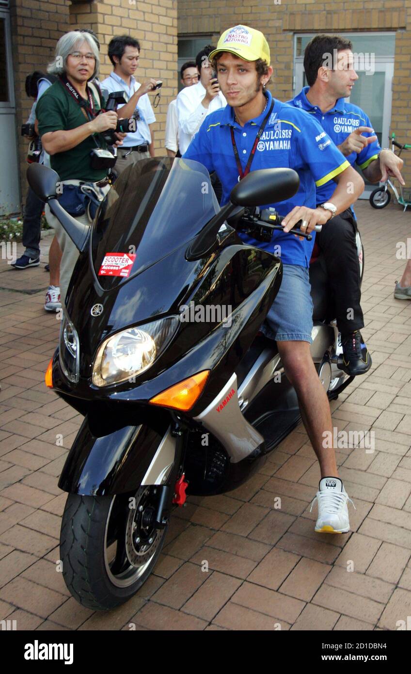 Italian MotoGP rider Valentino Rossi of Yamaha rides a scooter to leave a  news conference held before the Japanese Grand Prix of the 2005 MotoGP  World Championships at Twin Ring Motegi, north