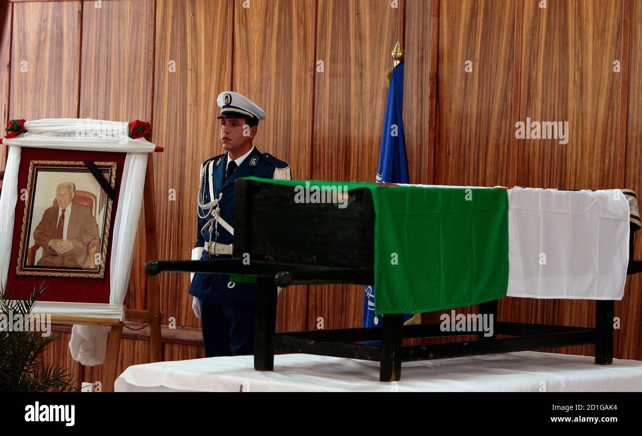 Algerian policemen pay respect to the flag draped coffin of national police chief Ali Tounsi at a ceremony to pay the last tribute at the police training academy in Algiers February 26,