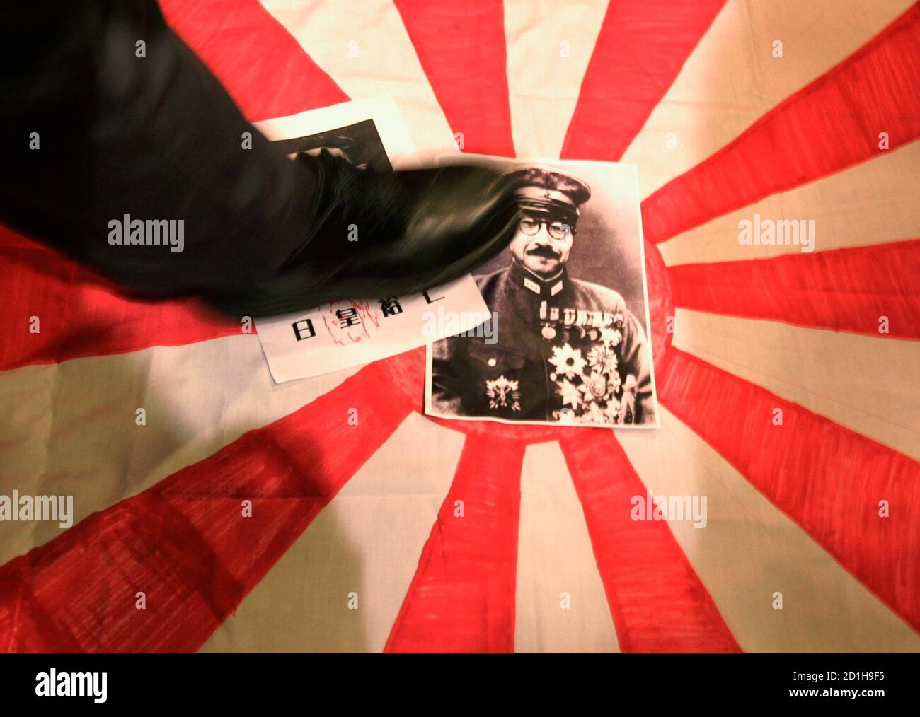 A Protester Steps On A Japanese Military Flag With A Photo Of Hideki Tojo A General In The Imperial Japanese Army And Prime Minister Of Japan During World War Ii To Commemorate