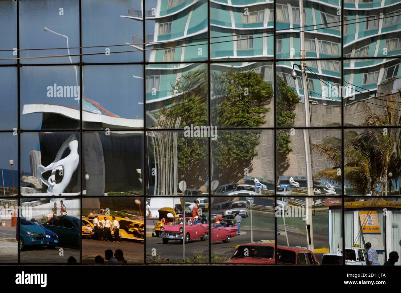 Reflection on mall windows show taxi drivers as they wait outside the  former casino of the Havana Riviera Hotel, built in 1957 by the notorious  mafia chief Meyer Lansky, in Havana April