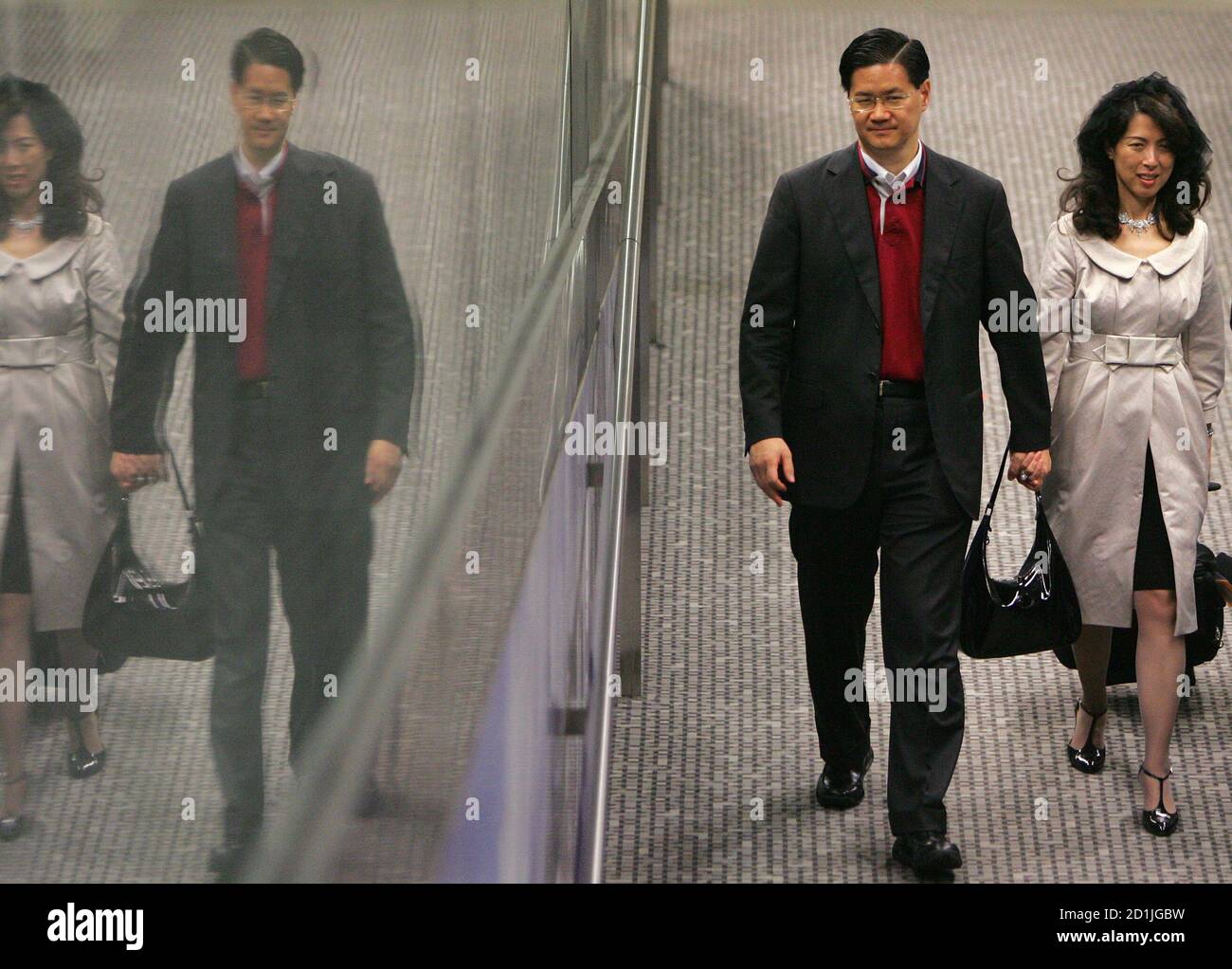 Oasis Hong Kong Airlines Chairman Raymond Lee and his wife Priscilla, also  executive director of the airline, leave the company's Boeing 747-400  passenger plane after it failed to leave Hong Kong during