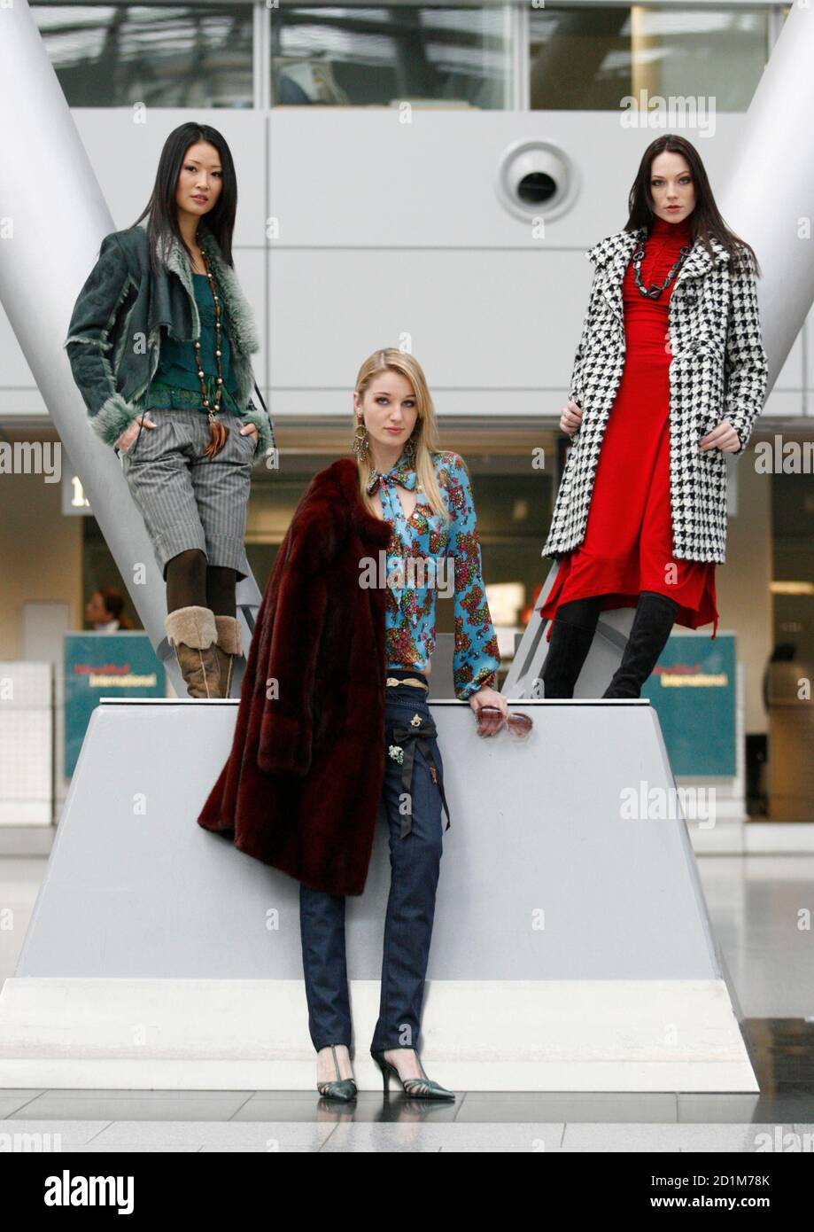 Models present creations by Spanish designer Muchacha (L), German designer  Bruno Voss (C), Italian designer I.C.A. (coat) and Spanish designer Isabel  de Pedro (red dress) during a preview for the Igedo Fashion