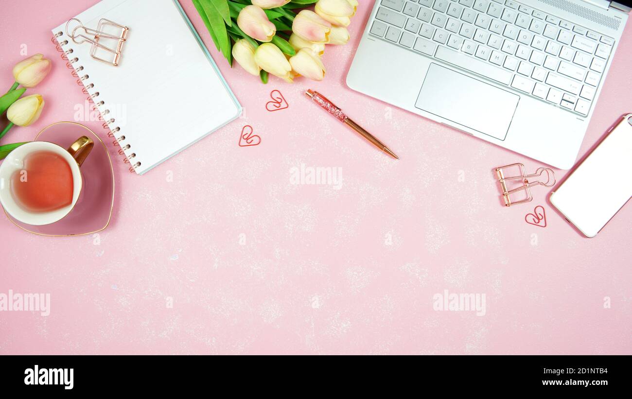 Espace de travail de bureau à thème rose féminin avec ordinateur portable  sur un arrière-plan texturé élégant. Top View blog HERO header composition  créative Flat lay Photo Stock - Alamy