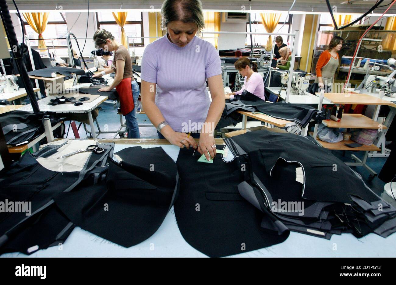 A Bosnian worker arranges clothing in the Borac garment maker in the  central town of Travnik June 3, 2009. The factory assembles clothing for  labels such as Hugo Boss, Pierre Cardin and