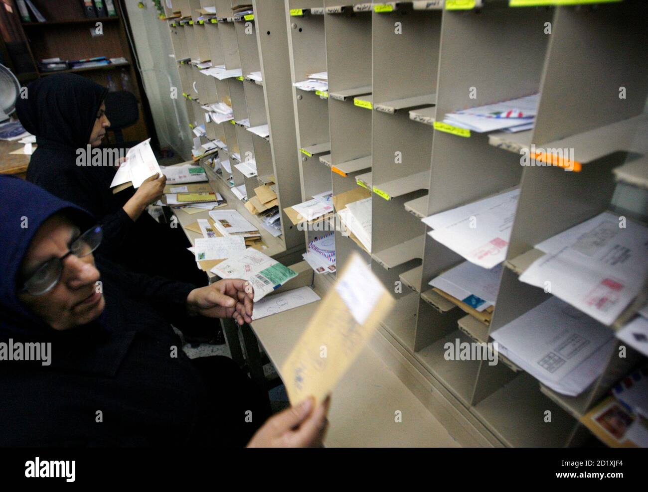 Employees sort mails at a post office 