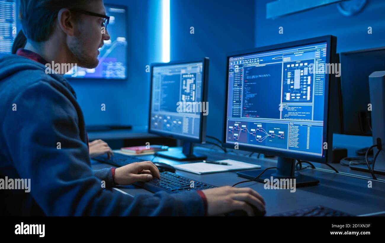 Smart Male IT Programer fonctionnant sur un ordinateur de bureau. Développement de logiciels rédaction de code conception de site Web Architecture de base de données. Service technique Banque D'Images