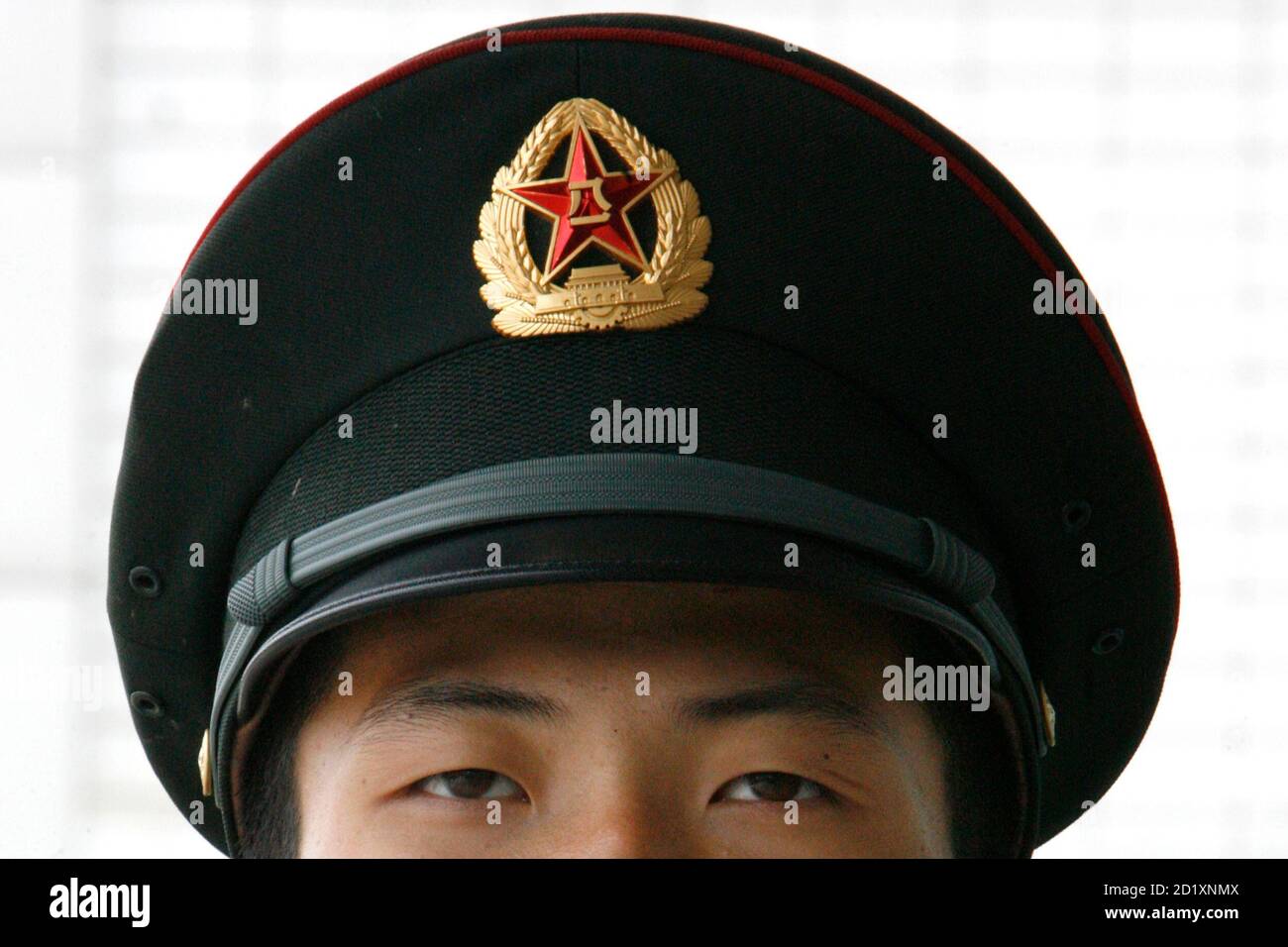 A People's Liberation Army soldier keeps watch during celebrations for the  anniversary of the founding of the Chinese People's Liberation Army (PLA)  at a military camp in Beijing August 1, 2008. Among