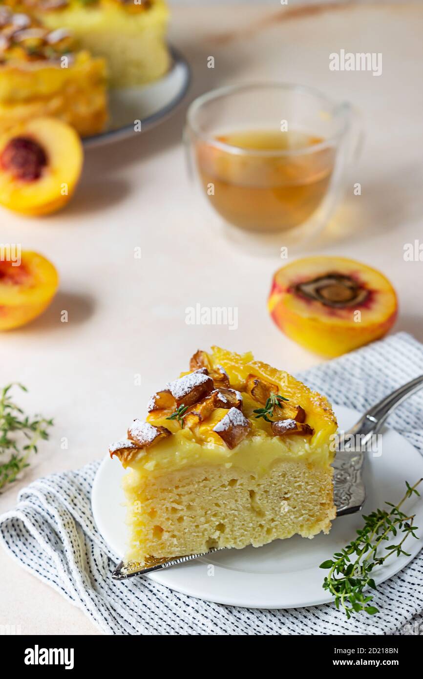 Delicieux Gateau En Mousseline Avec Creme Anglaise Et Nectarines Avec Tisane Et Thym Sur Fond De Beton Leger Photo Stock Alamy