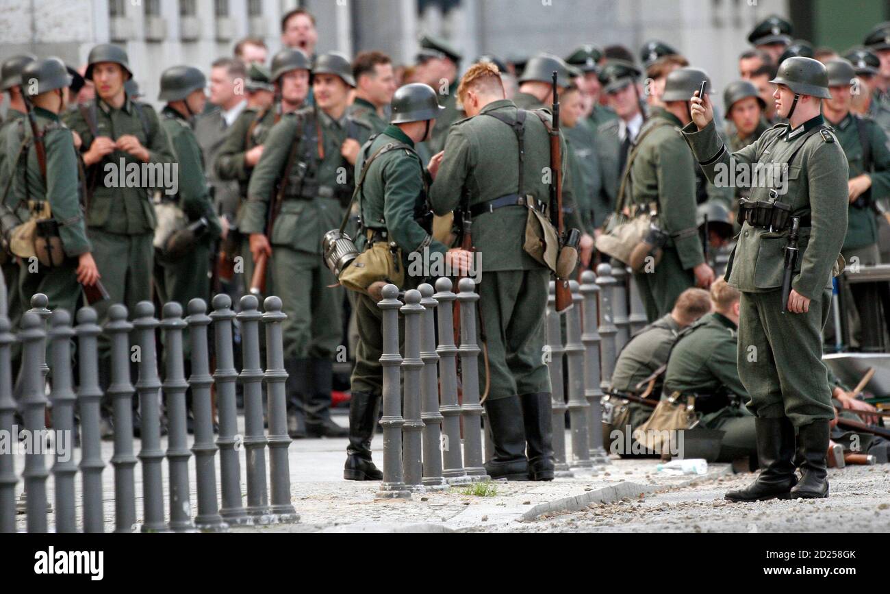 Actors dressed as German Wehrmacht soldiers pause during the shooting of a  scene of 'Valkyrie' in front of the German Finance Ministry, the former  Reichsluftfahrtministerium (Air Force Ministry), in Berlin August 19,
