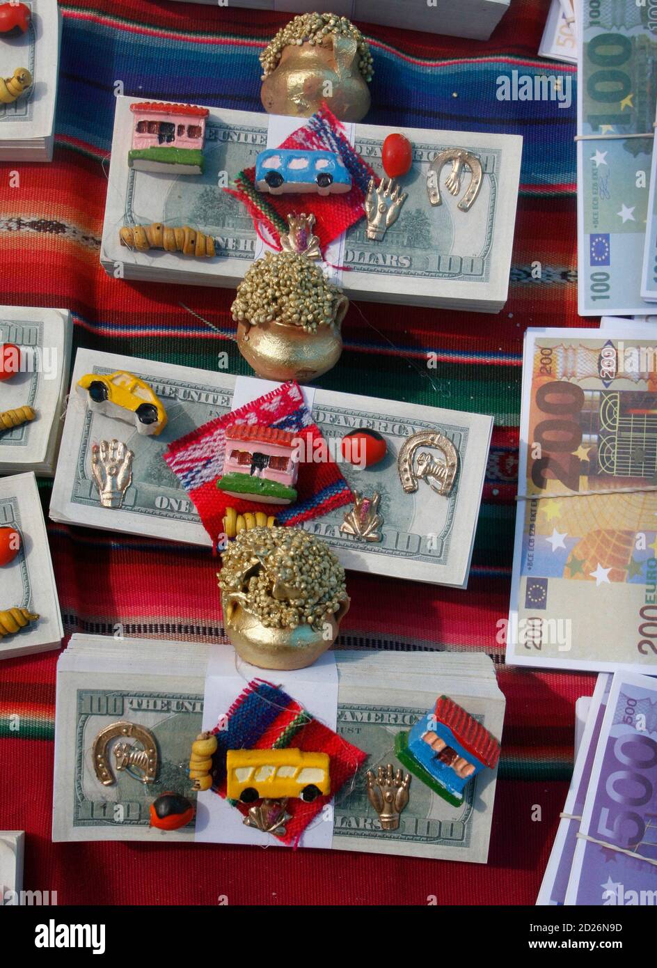 Packages of miniature dollar bills and euros lie on a vendor's table during  the celebration of the Virgin of Urkupina on the outskirts of La Paz August  15, 2007. The annual festival