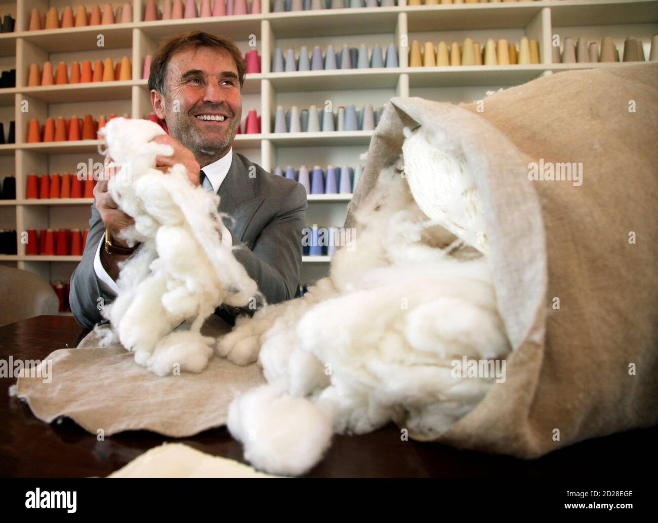 Italian clothing designer Brunello Cucinelli holds raw cashmere wool in the  Umbrian village of Solomeo October 7, 2009. He has been called the King of  Cashmere, an entrepreneur with the mind of