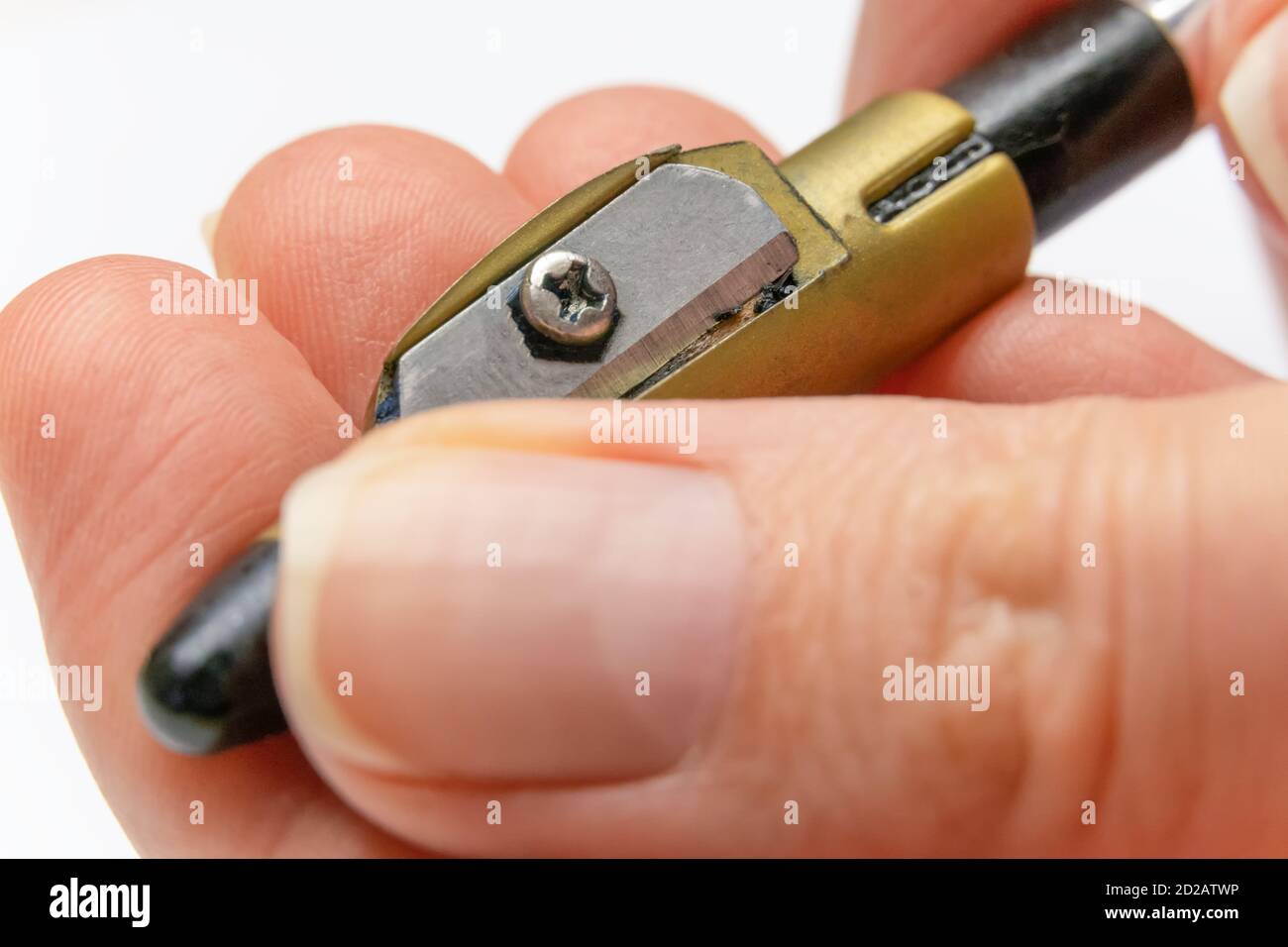 la main d'une femme aiguise un crayon pour les yeux avec un taille-crayon, la photographie macro Banque D'Images