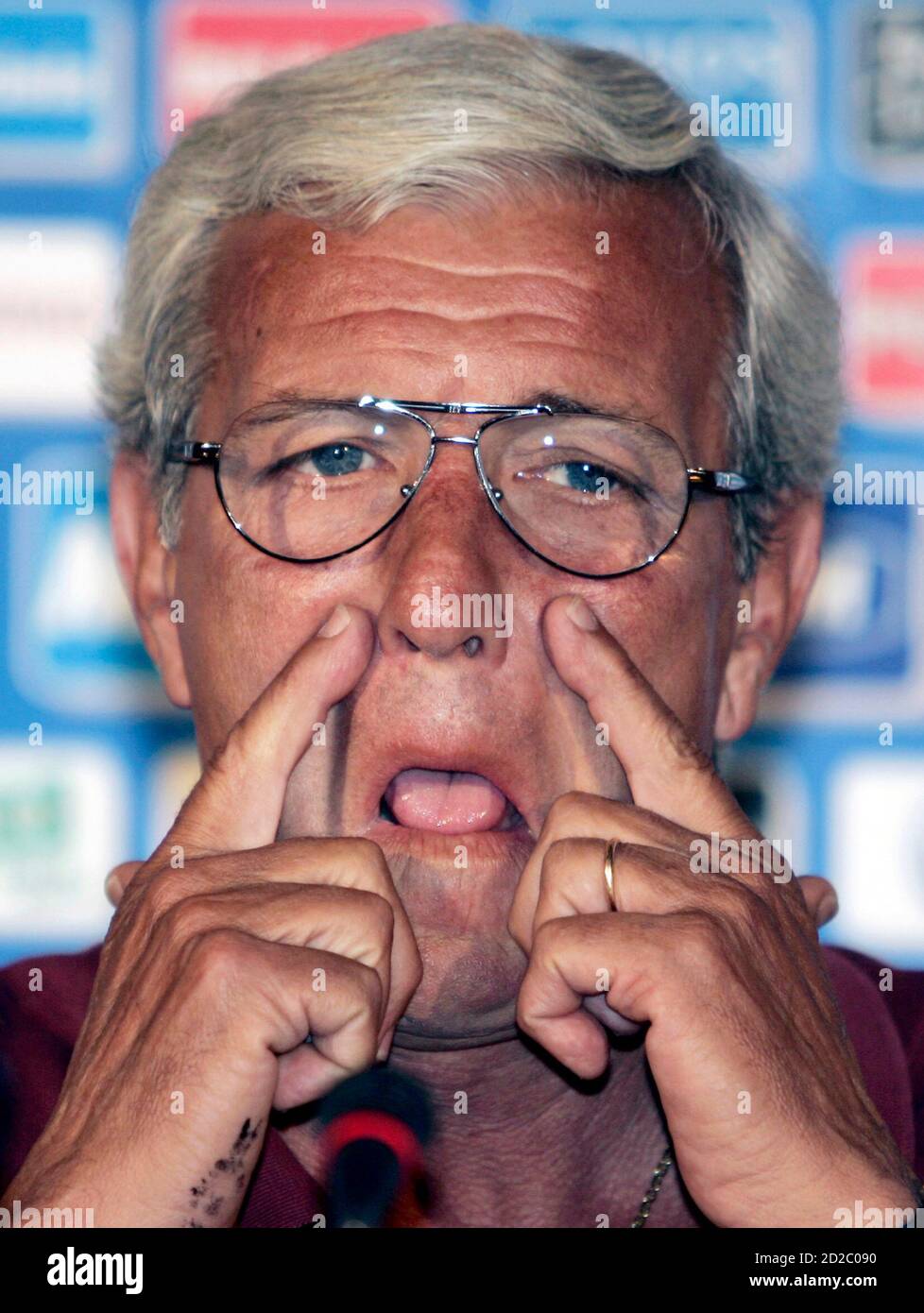 Italy's national soccer team coach Marcello Lippi speaks to reporters at a  training camp in Coverciano, Italy May 27, 2006. Lippi knew his son was  likely to be drawn into the scandal