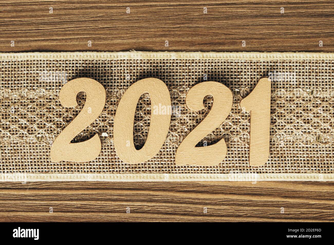 Nouvelle année 2021. Numéros dorés sur un ruban vintage festif sur un fond en bois. Noël, composition du nouvel an avec espace de texte. Vue de dessus. Banque D'Images