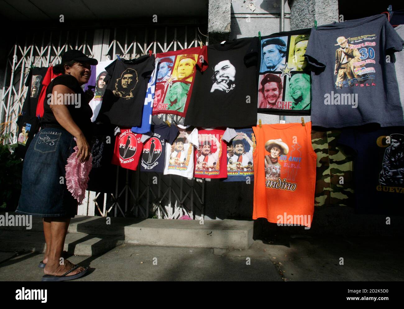 A woman sells T-shirts with the images of revolutionary leader Che Guevara  and Sandinista leader Augusto Sandino at Revolution Square in Managua July  18, 2009. Thousands of Sandinistas are preparing to celebrate