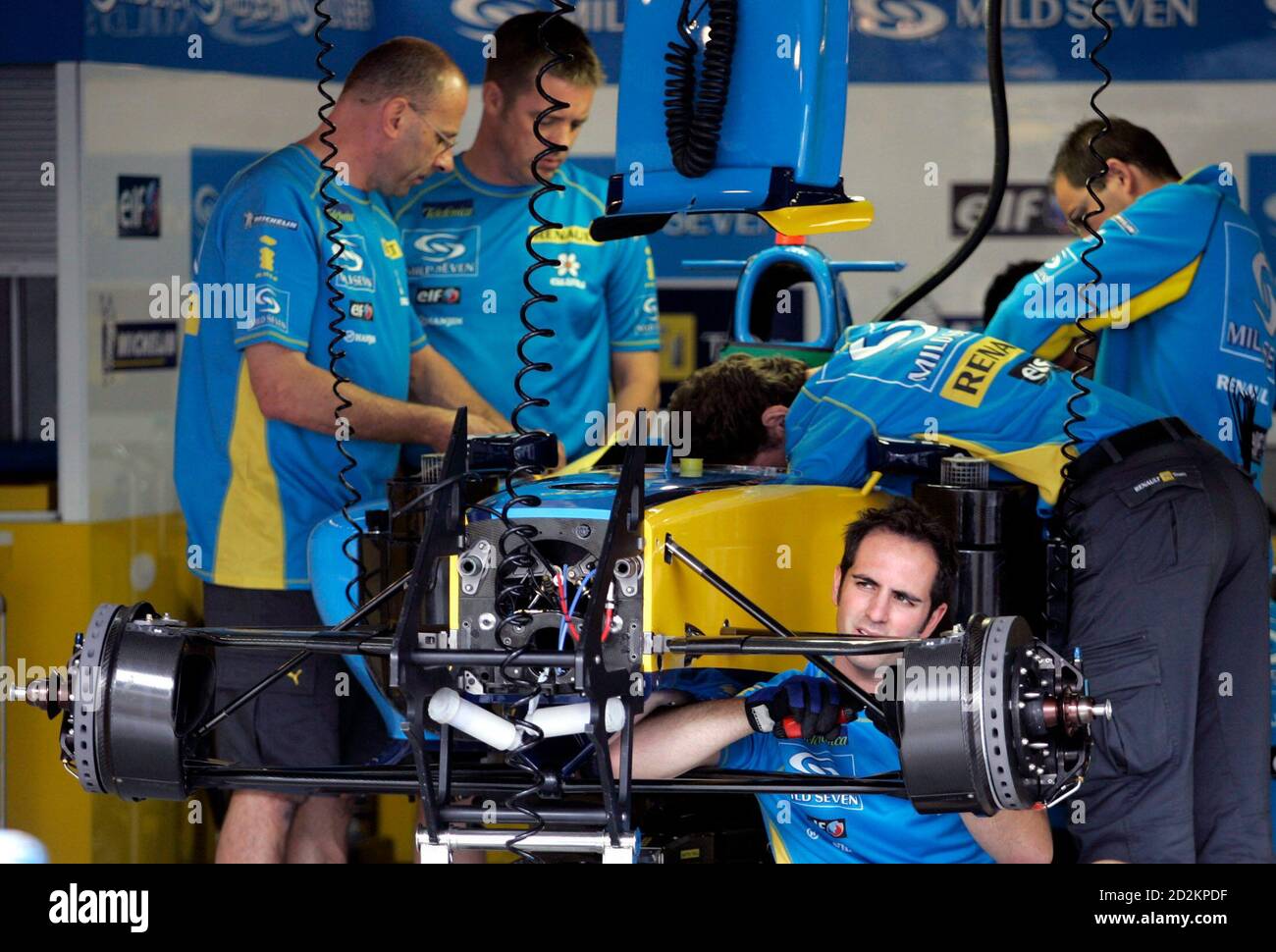 Mechanics Of Renault Formula One Team Work On Fernando Alonso S F 1 Car In The Pit At Interlagos Racetrack Mechanics Of Renault Formula One Team Work On Fernando Alonso S F 1 Car In The