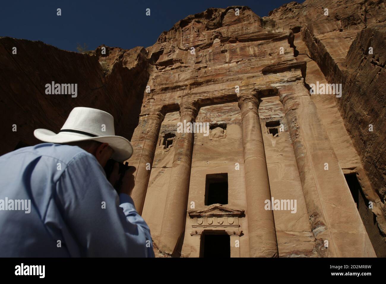 An Australian tourist takes pictures of the archaeological court building  in Petra July 9, 2007. The Great Wall of China, Petra in Jordan and  Brazil's statue of Christ the Redeemer are among