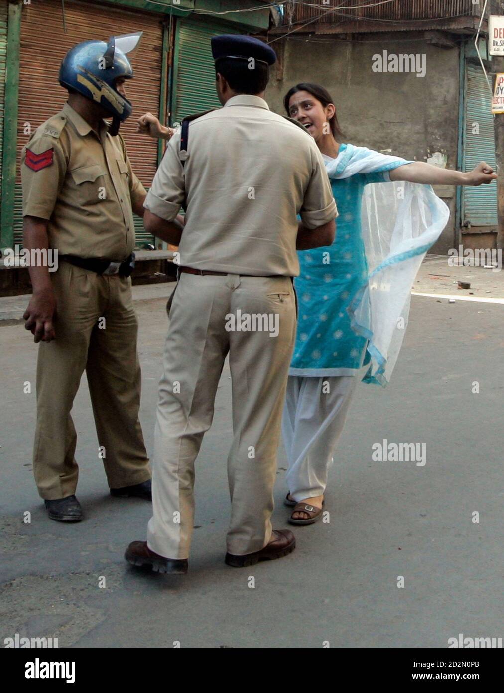 A Kashmiri woman argues with Indian police officers during a protest in  Srinagar June 30, 2009. Separatists on Tuesday called for a strike to  protest against the killing of two civilians by