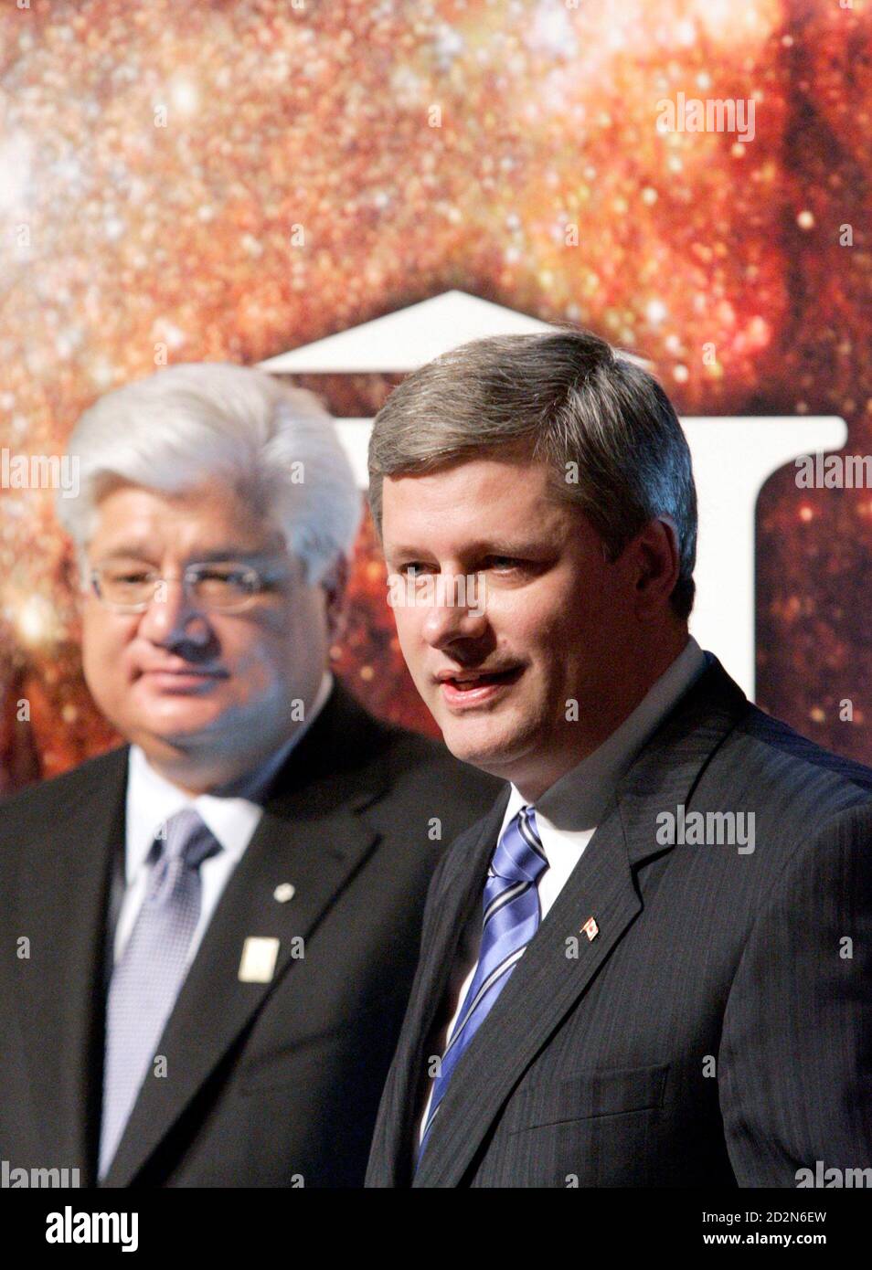 Canadian Prime Minister Stephen Harper (R) appears on stage with Research  in Motion Co-CEO Mike Lazaridis while announcing a funding boost for  science and technology at the Perimeter Institute for Theoretical Physics