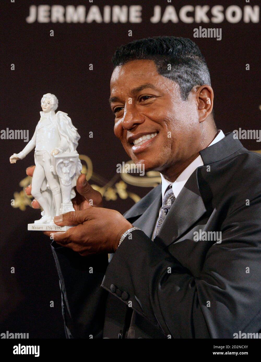 Jermaine Jackson displays a statue of Wolfgang Amadeus Mozart after a news  conference in Vienna September 8, 2009. Artists including R&B stars Mary J.  Blige, Akon and Chris Brown as well as