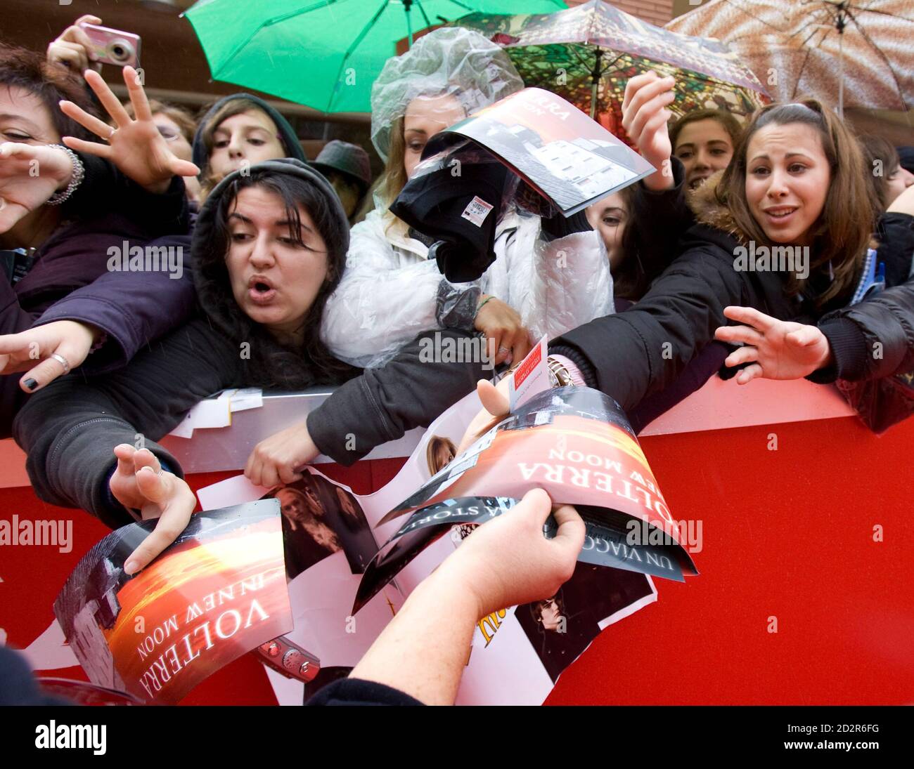 Fans reach out for souvenirs before a preview of clips from the