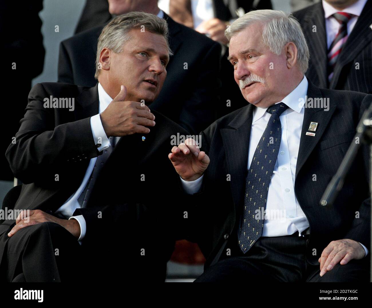 Poland's President Aleksander Kwasniewski (L) and former president Lech  Walesa chat near the main gate to the Gdansk Shipyard August 31, 2005.  Representatives of 30 governments, human rights activists and historians  have