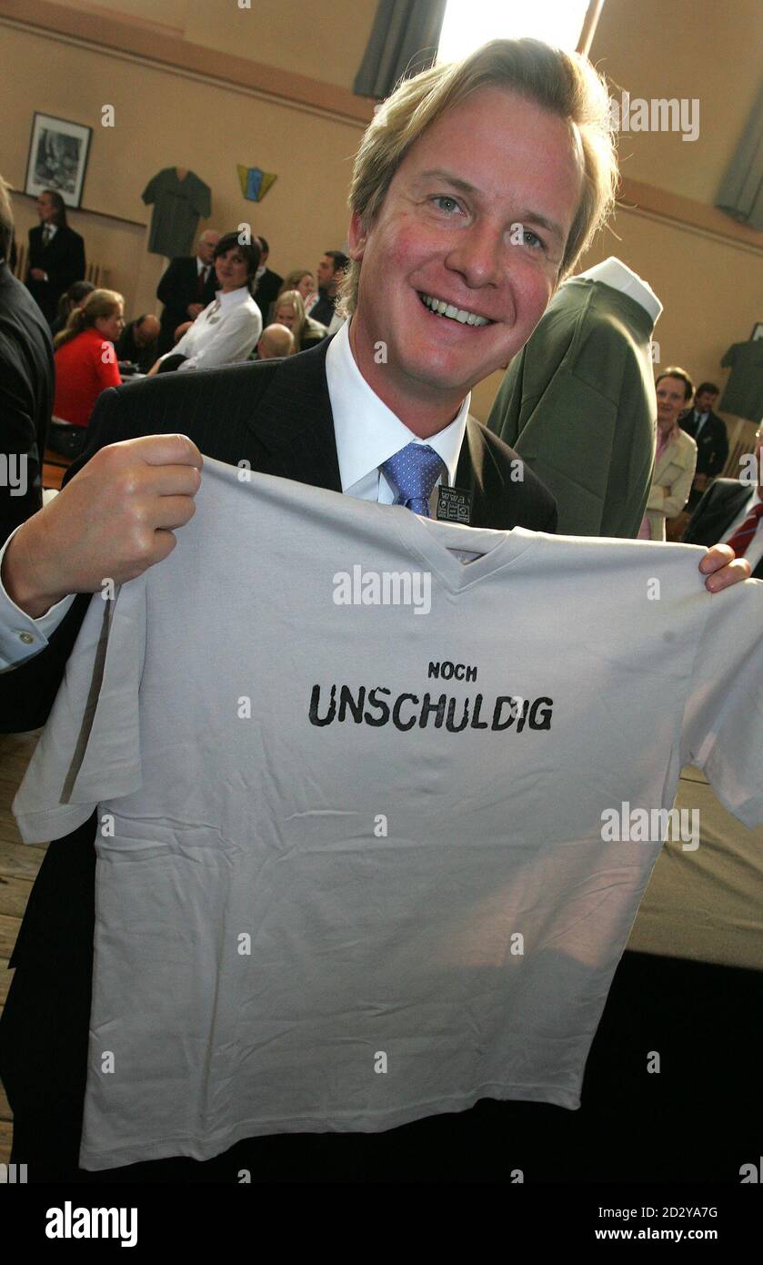 Hamburg's Senator of Justice Carsten Luedemann poses with a T-shirt reading  'Noch Unschuldig' (not yet guilty) during a presentation at the  Fuhlsbuettel prison in Hamburg September 28, 2006. Luedemann today  introduced a